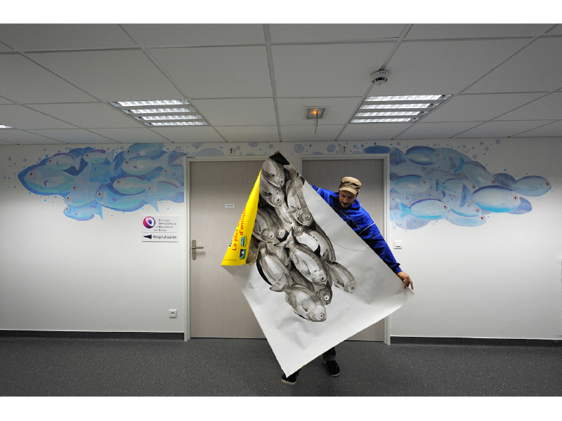 man with quiff and brown tinted sunglasses wearing a fur collar